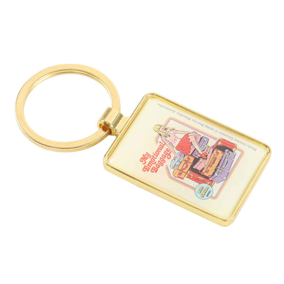 Steven Rhodes enamel keyring depicting a young woman sitting on top of a pile of stacked suitcases. Text reads My Emotional Baggage.