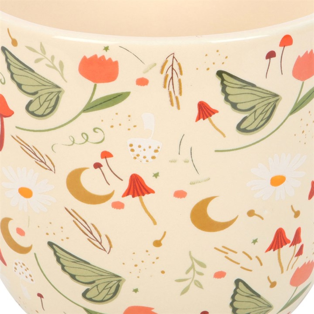Ceramic plant pot with a gloss white finish. Cottagecore style design, including fairy wings, toadstools and crescent moons. Close up.