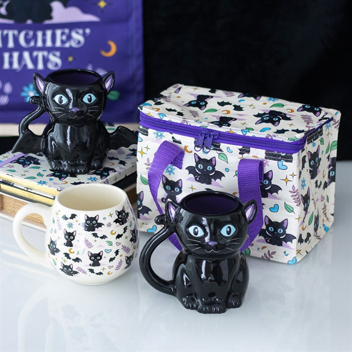 Insulated lunch bag with adorable cute and creepy cat pattern. Presented alongside other items from the same range.