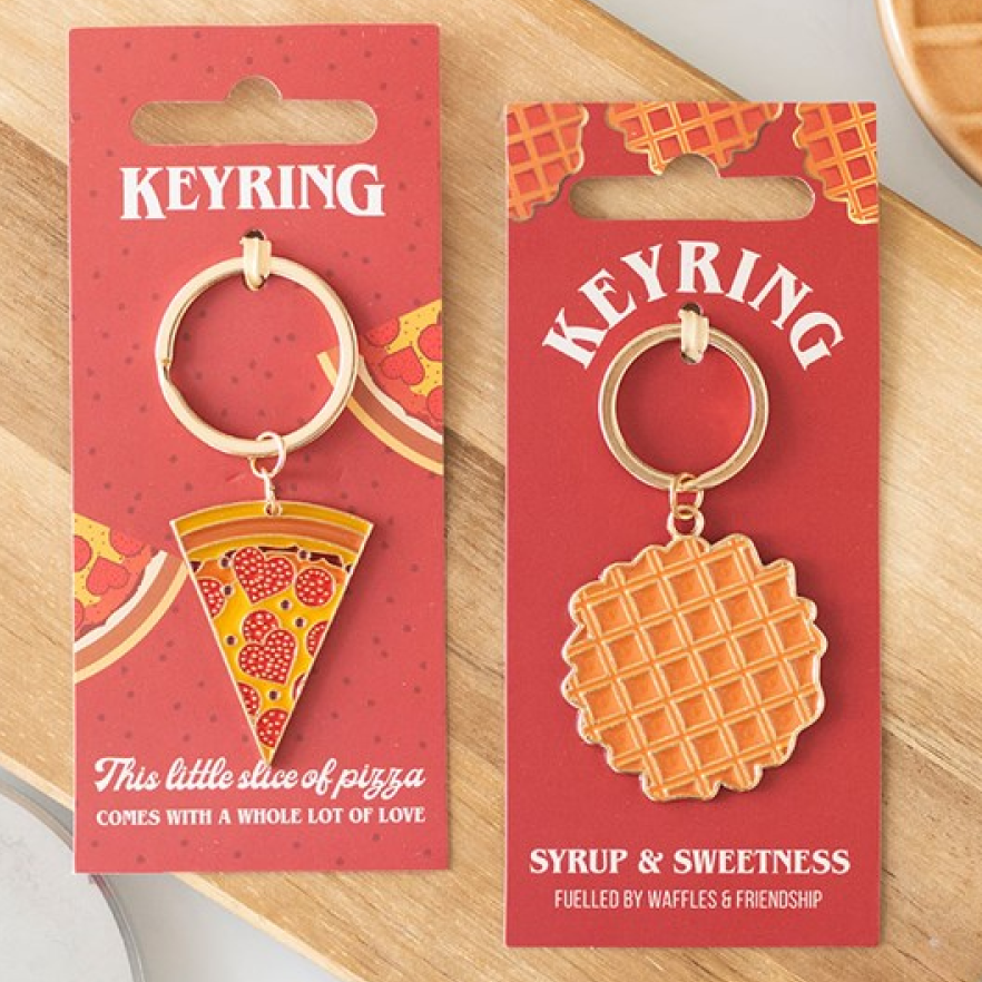 Waffle-shaped keychain presented on a themed background. Presented alongside pizza slice keyring from the same range.