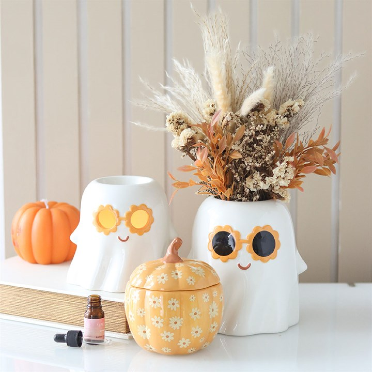 Groovy Ghost ceramic flower vase. Adorable ghost shape with 60s style sunflower sunglasses. Displayed with other items from the same range.