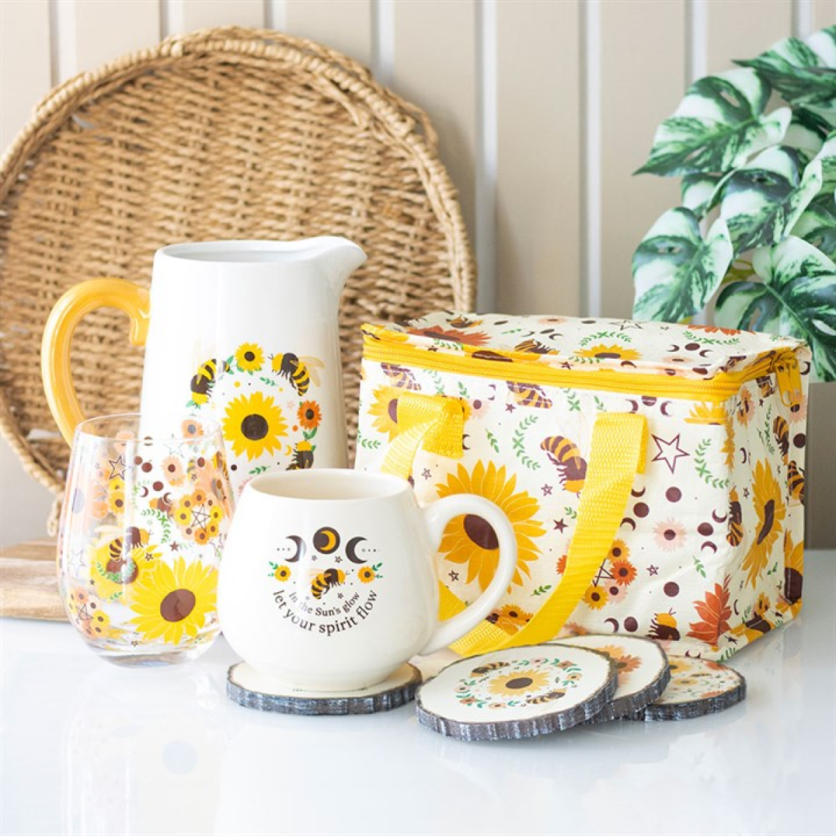 White flower jug pitcher featuring sunflower and bee motif with colourful yellow handle. Presented alongside other items from the same range.