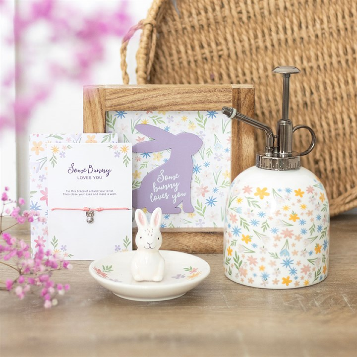 Ceramic plant mister finished with a pastel-hued spring florals motif and a silver effect spray pump. Presented alongside other items from the same range.