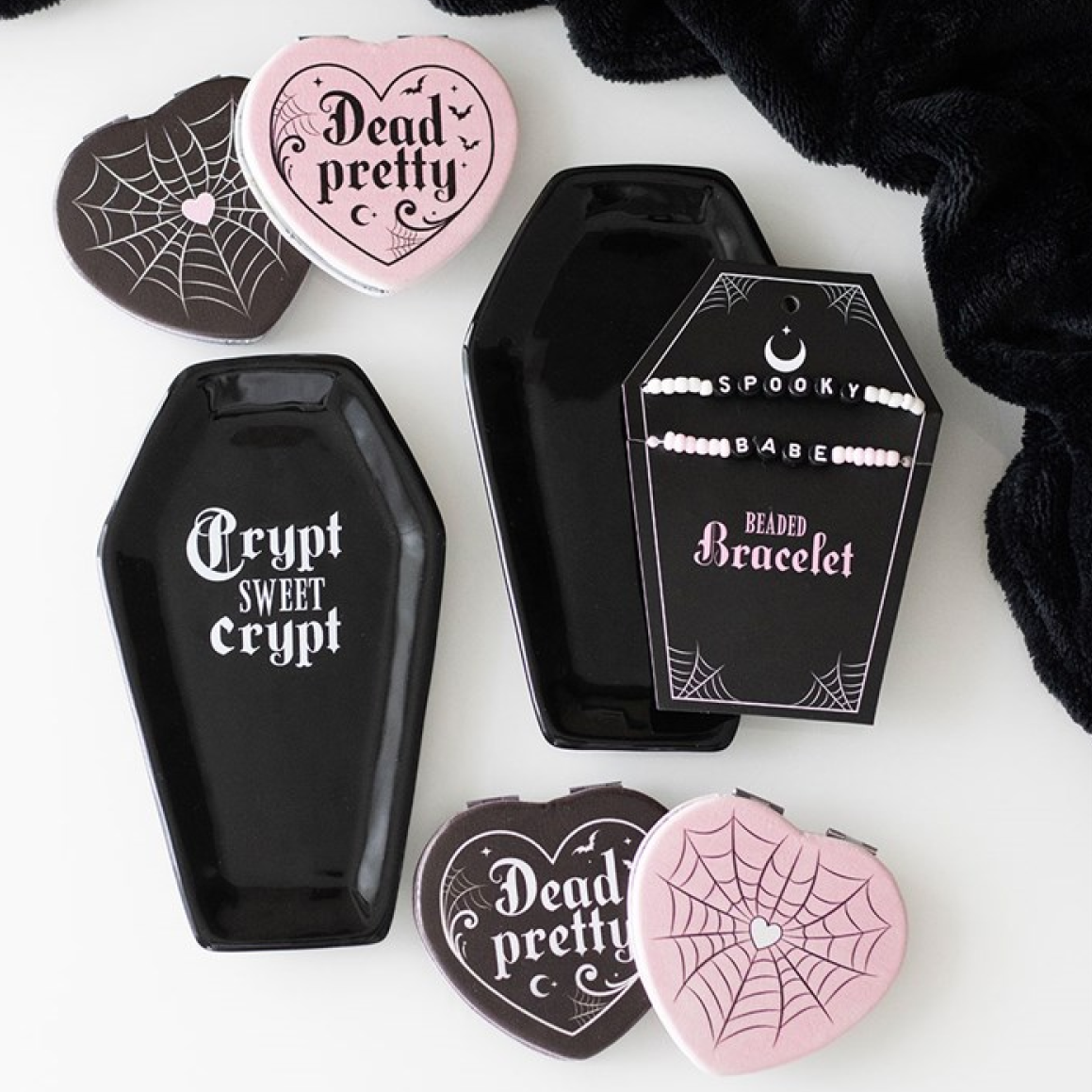 Black coffin-shaped trinket dish, with cheeky 'Crypt Sweet Crypt' text. Presented alongside other items from the same range.