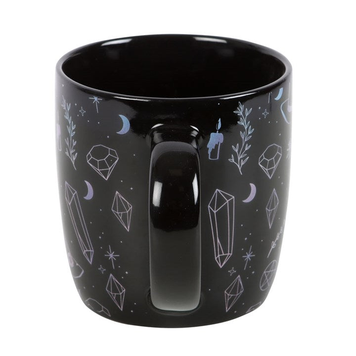 Black ceramic mug with white crystal witch style illustrations.