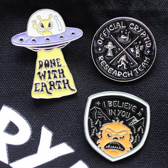 Enamel pin featuring a close up of Bigfoots face, woodland accents and adorable I Believe In You text. Presented alongside other items from the same range.