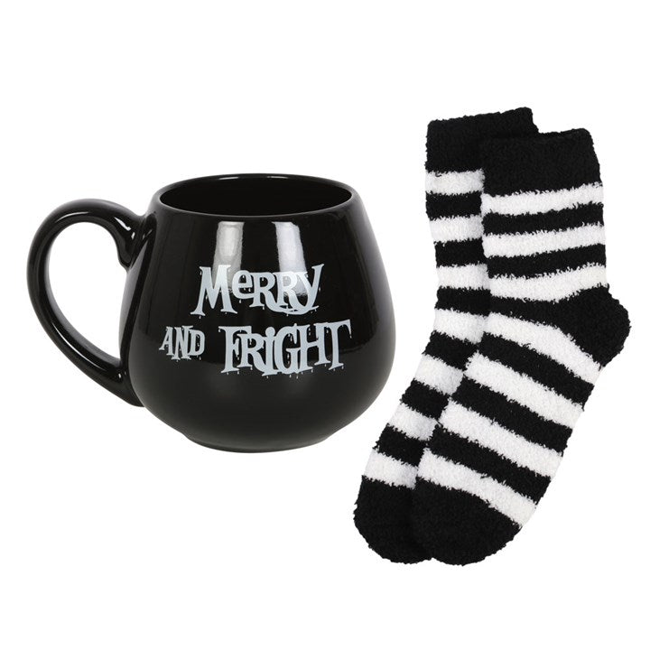 Black ceramic rounded mug with Merry and Fright text, plus a matching set of black and white striped fluffy socks.