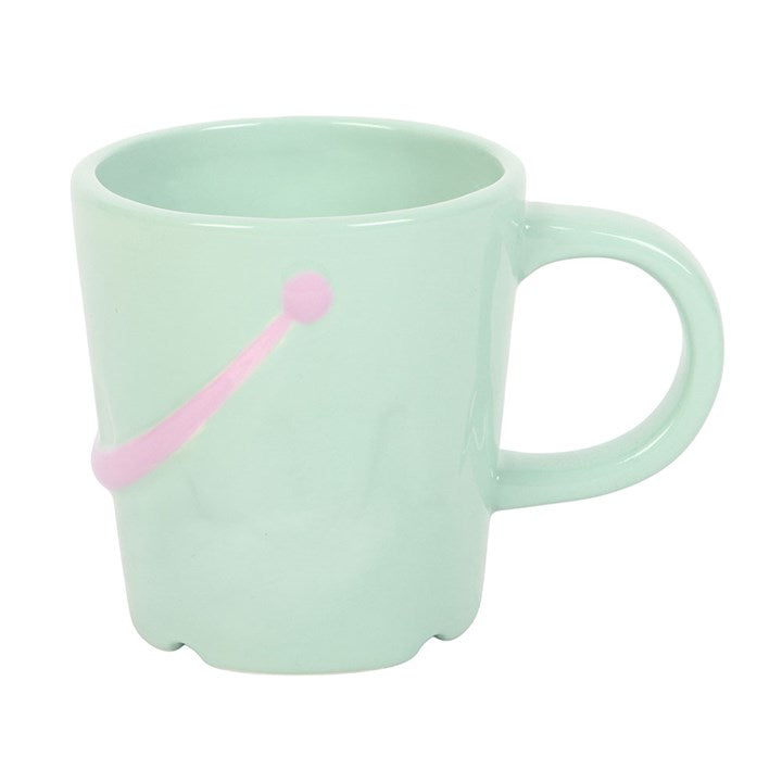 Ceramic sandcastle bucket shaped mug with spade-shaped spoon. Alternative pastel colouring.