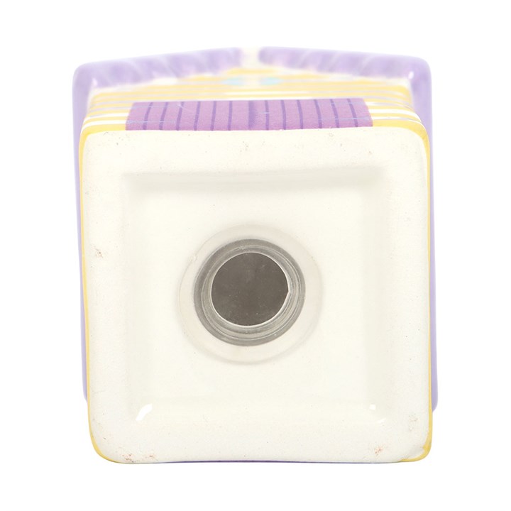 close up of stopper on the bottom of a ceramic pastel striped beach-hut shaped salt shaker.