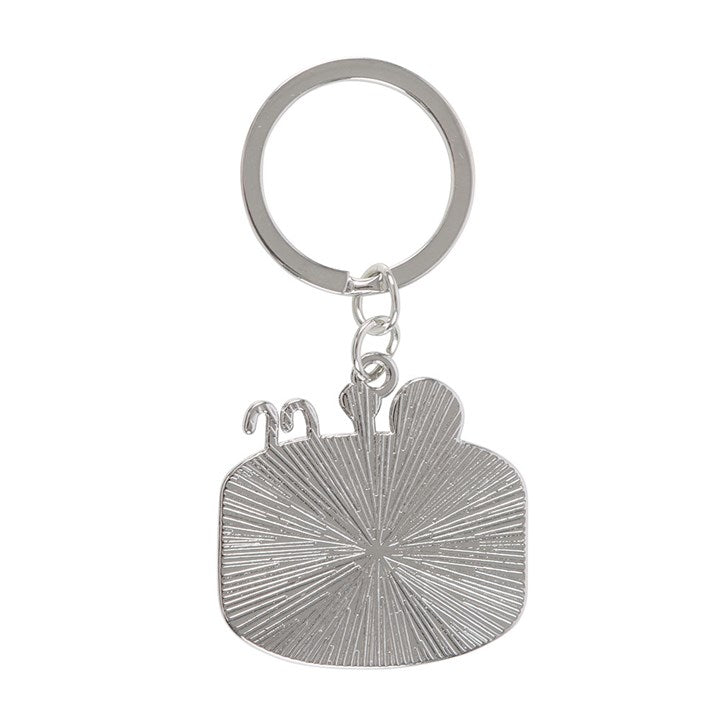 Dead Cool enamel keyring shaped like a skeleton chilling in a pink swimming pool. Reverse view.