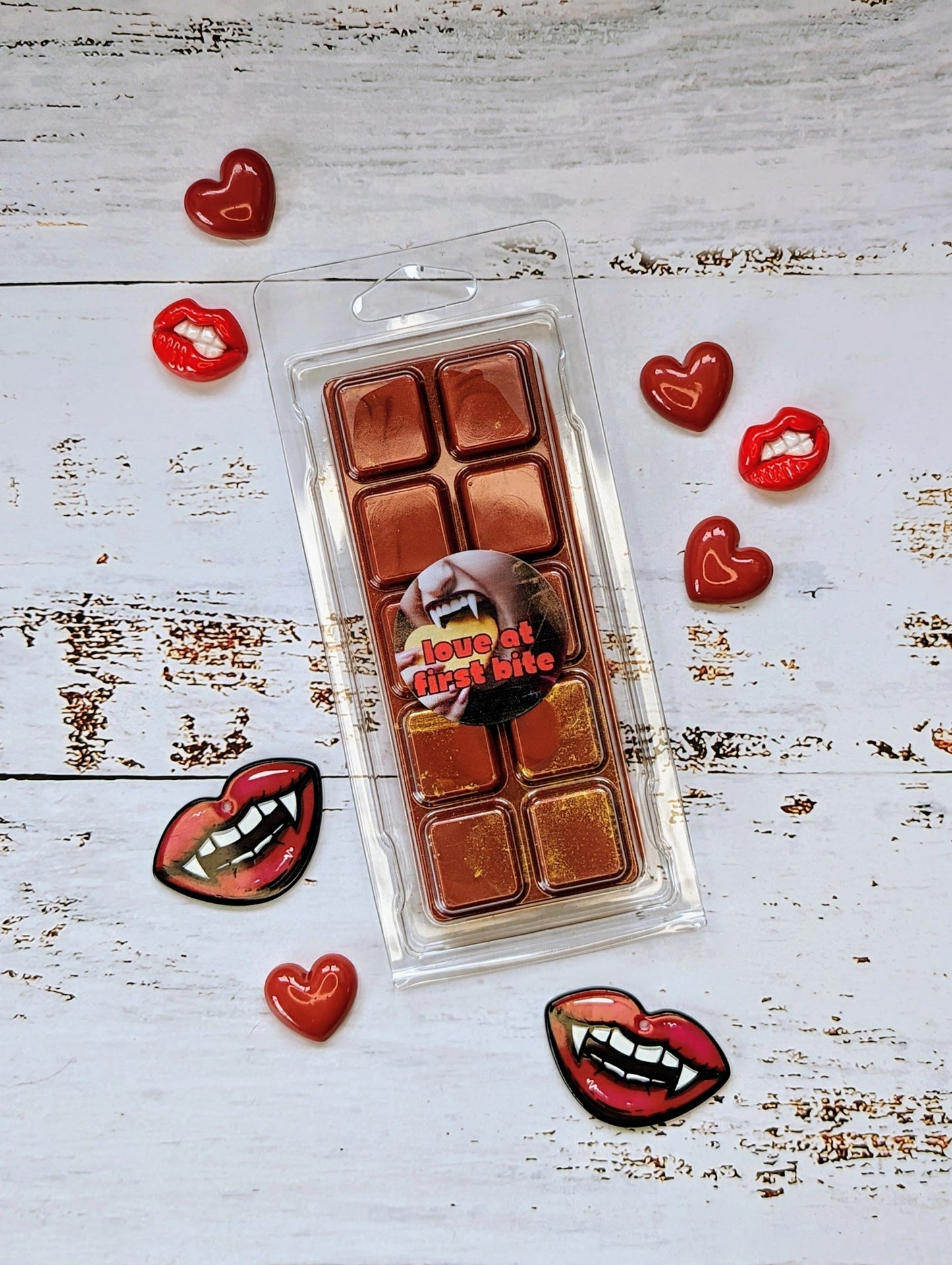 Love At First Bite coconut wax melt. Deep red snap bar with golden shimmer accents.
