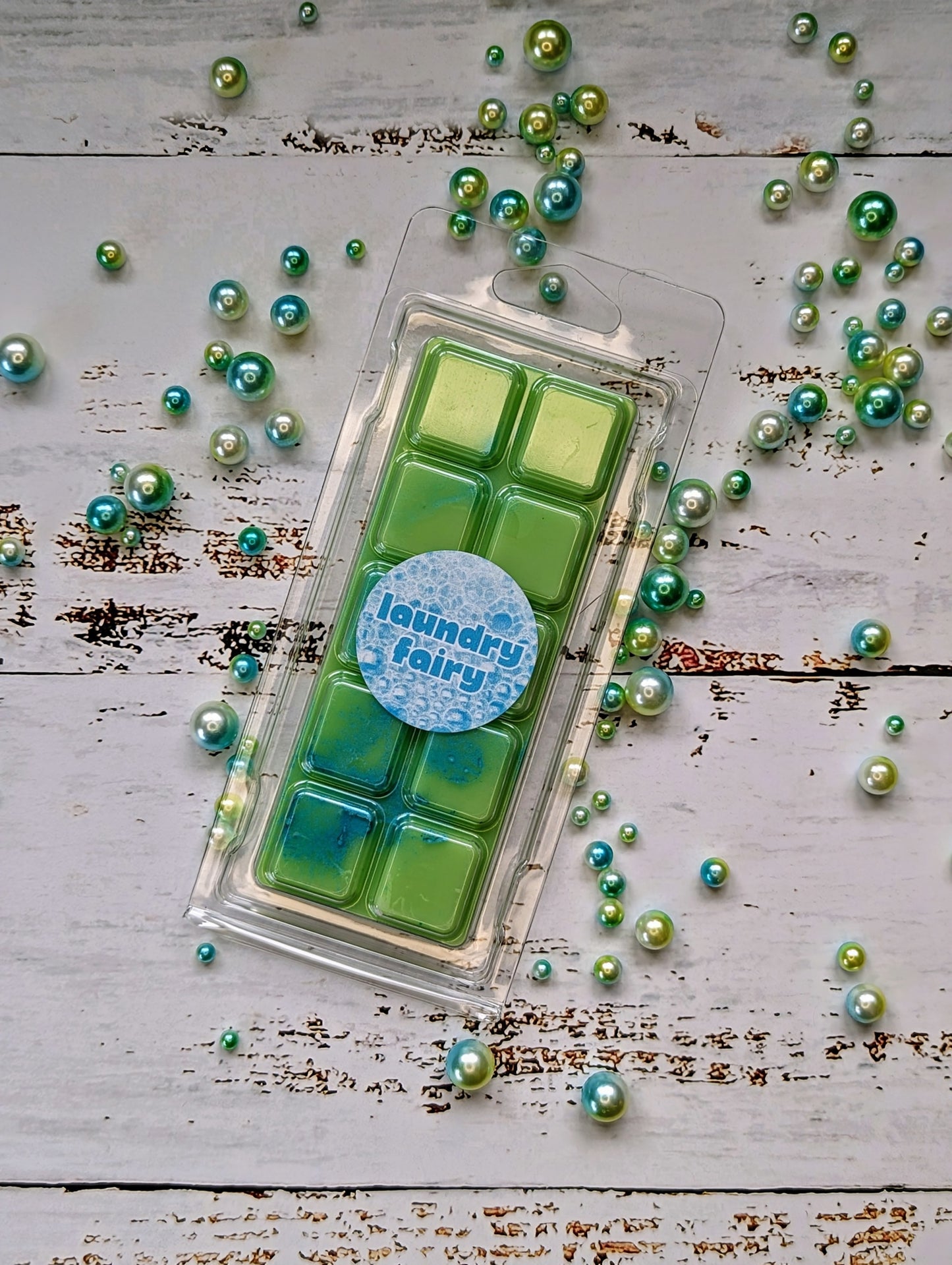 Laundry Fairy coconut wax melt. Light green snap bar with blue and green shimmer accents.