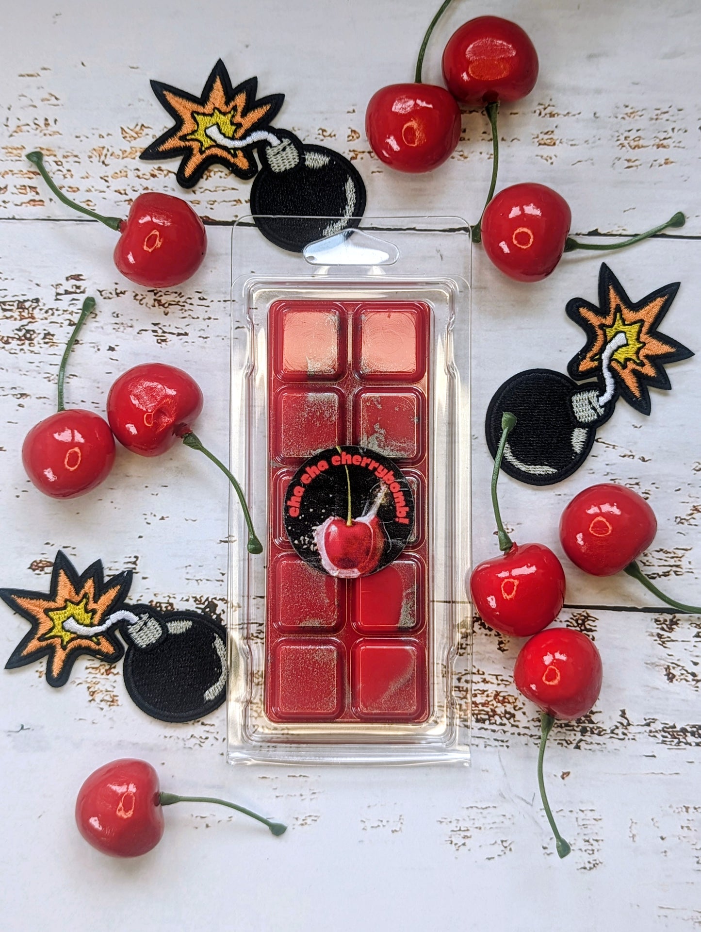 Cha Cha Cherrybomb! coconut wax melt. Bright red snap bar with silver metallic shimmer accents.