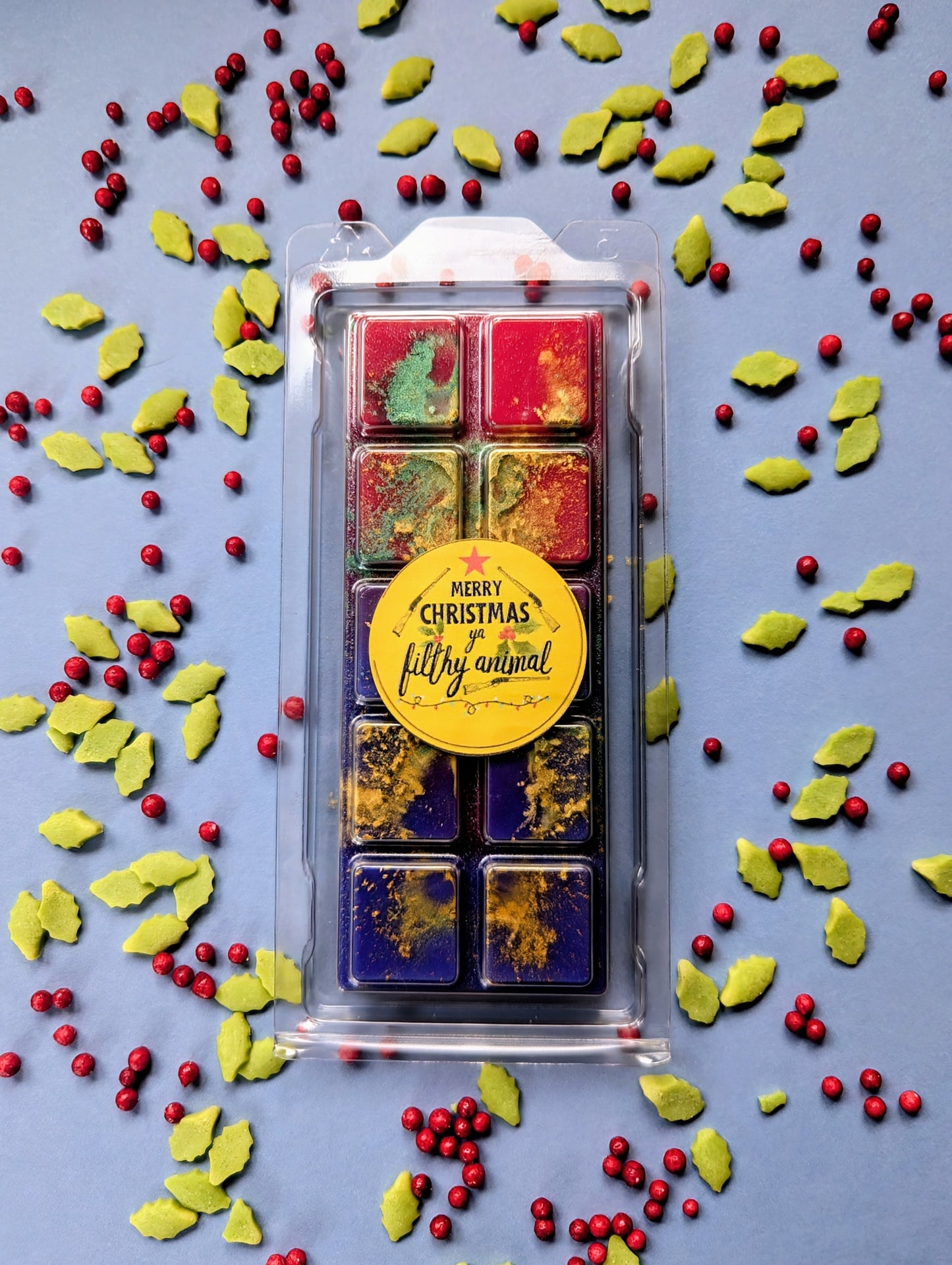 Merry Christmas Ya Filthy Animal coconut wax melt. Red and blue snap bar with gold and green shimmer accents.