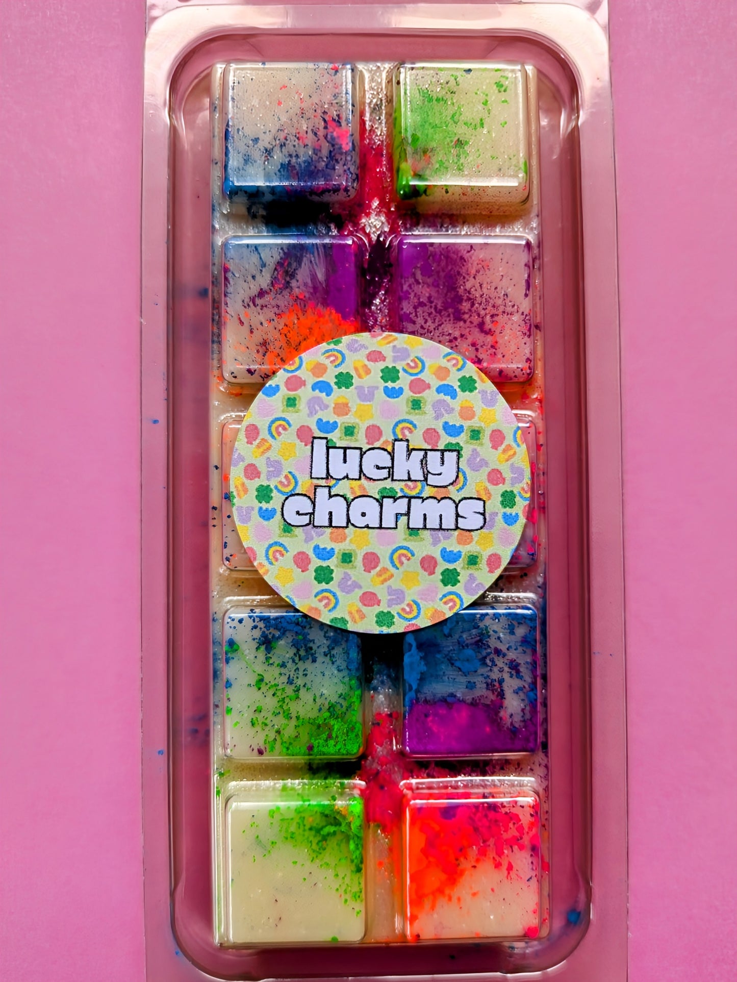 Lucky Charms coconut wax melt. Cream snap bar with green, blue, pink and orange shimmer accents.