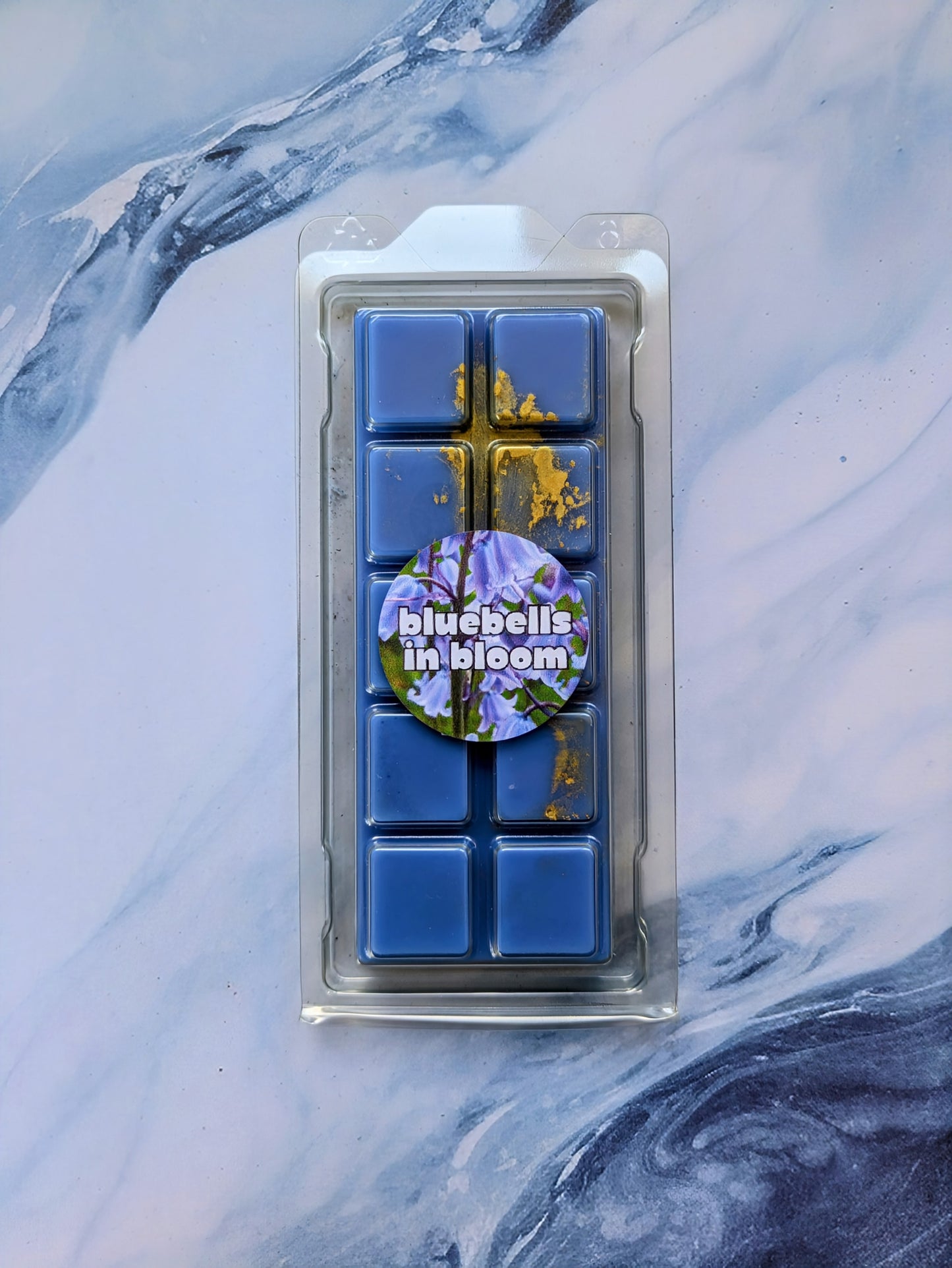 Bluebells in Bloom coconut wax melt. Deep blue snap bar with yellow and gold shimmer accents.