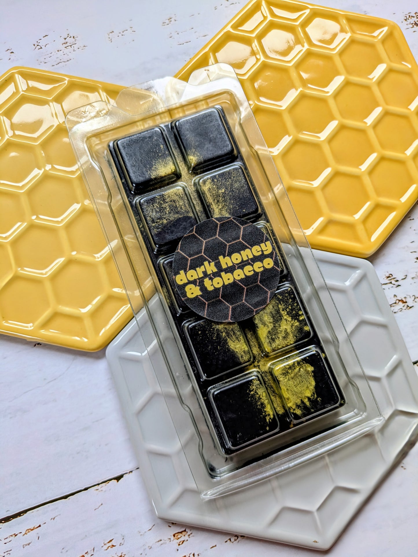 Dark Honey and Tobacco coconut wax melt. Black snap bar with fluorescent yellow shimmer accents.