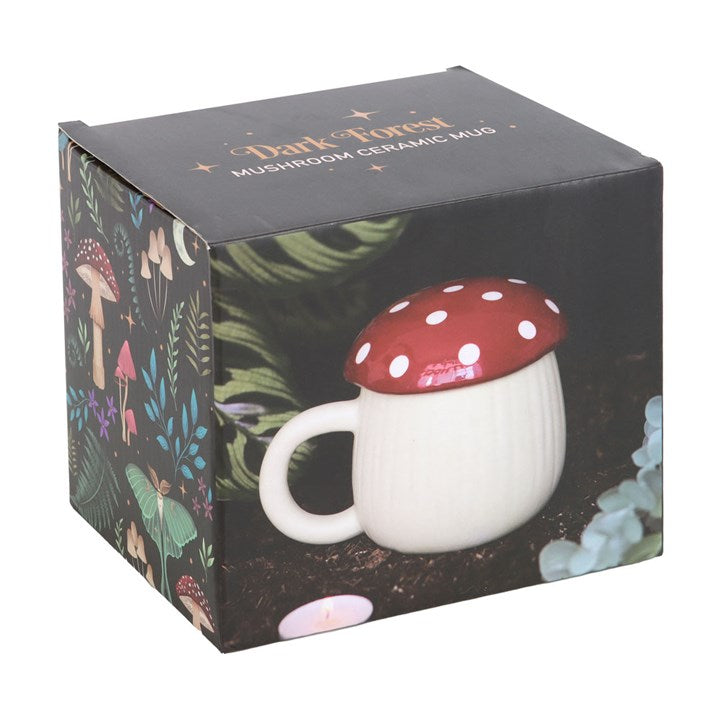 Ceramic lidded mug shaped like a fly agaric mushroom. Presented in a themed box.