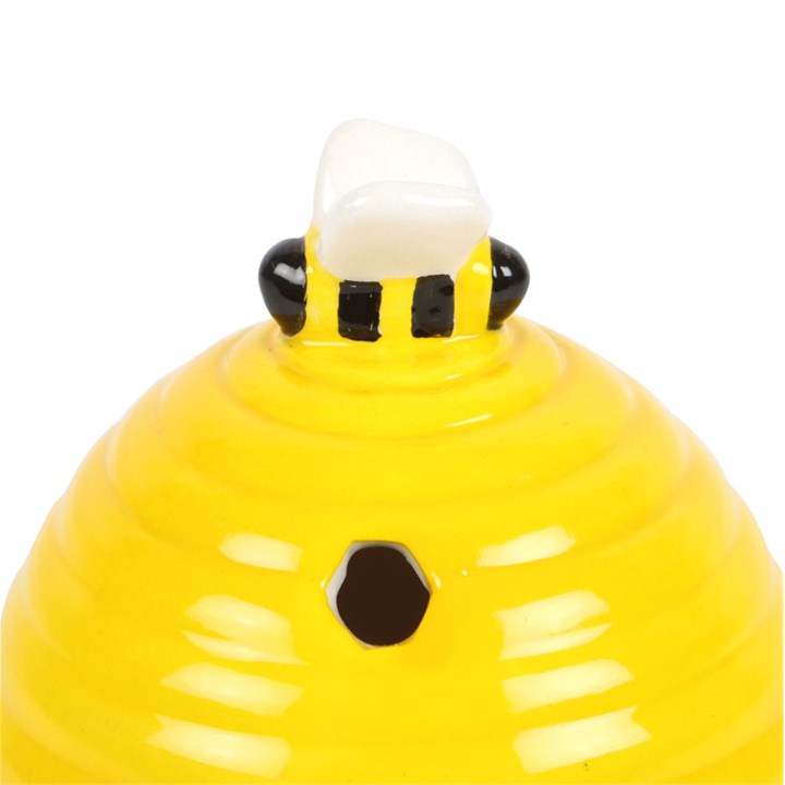 Yellow beehive shaped incense cone burner, with bee topper and honeycomb cut outs.