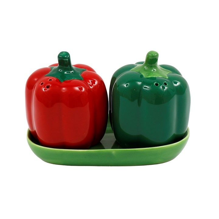 Pair of red and green pepper shaped salt and pepper shakers, presented on a green tray.