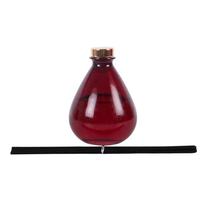 Dragon's Blood reed diffuser, presented in a deep purple teardrop glass bottle.