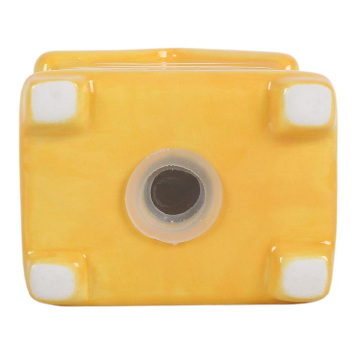 A set of white and yellow ceramic salt and pepper shakers, shaped like traditional beehives with a bee sitting on top.