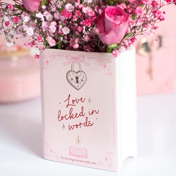 Ceramic book shaped vase, finished with charming heart-shaped lock accents and 'Love Locked in Words' text.