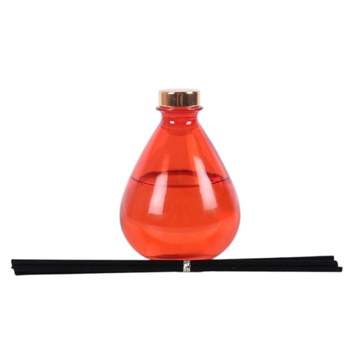 Blood Orange reed diffuser, presented in a deep orange teardrop bottle with black reeds. 