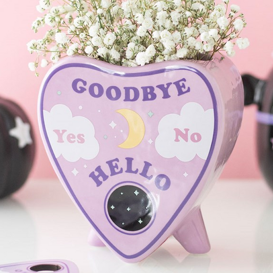 Pastel hued planchette shaped flower vase with charming celestial accents.