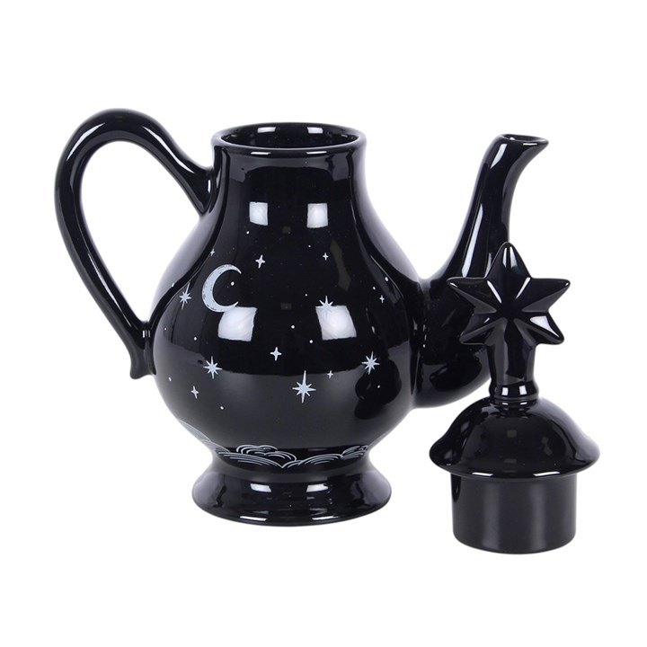 Striking tea pot with celestial design on a black background and a star-capped lid. 
