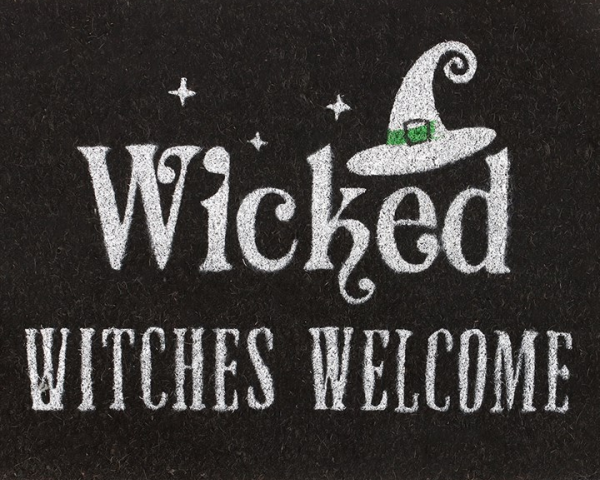 Black decorative doormat with 'Wicked Witches Welcome' text and a witch's hat graphic on black background.