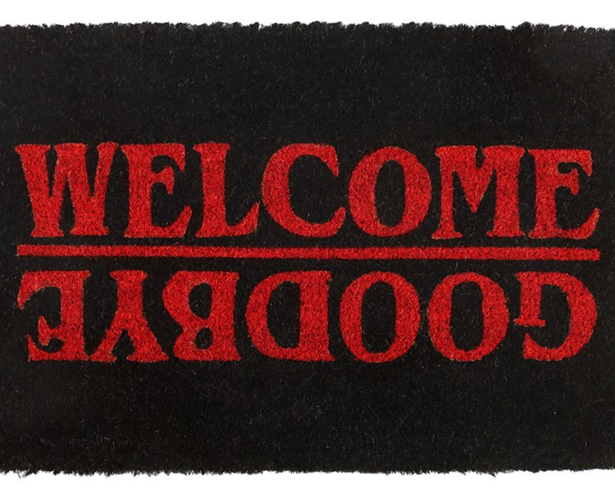 Black natural-fibre door mat, designed with striking red Welcome / Goodbye text on a jet black background. Stranger Things-inspired design. 
