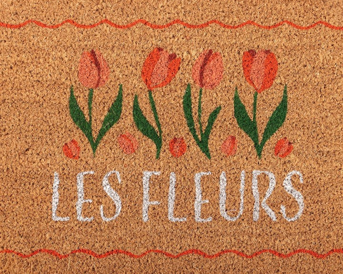 Decorative natural doormat with tulip design and 'Les Fleurs' text.