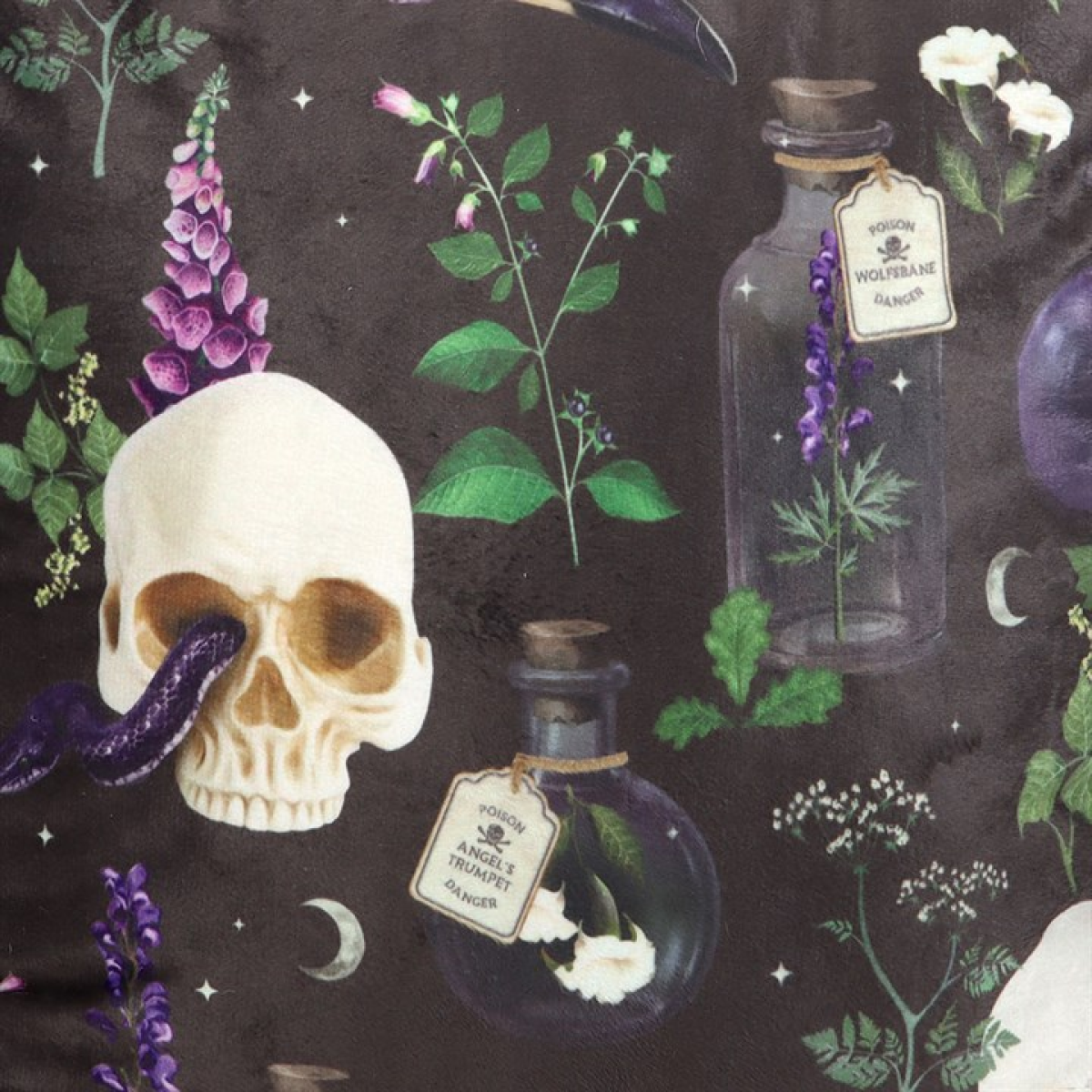 Square cushions with skulls, serpents and poisonous plants motif. Close up.