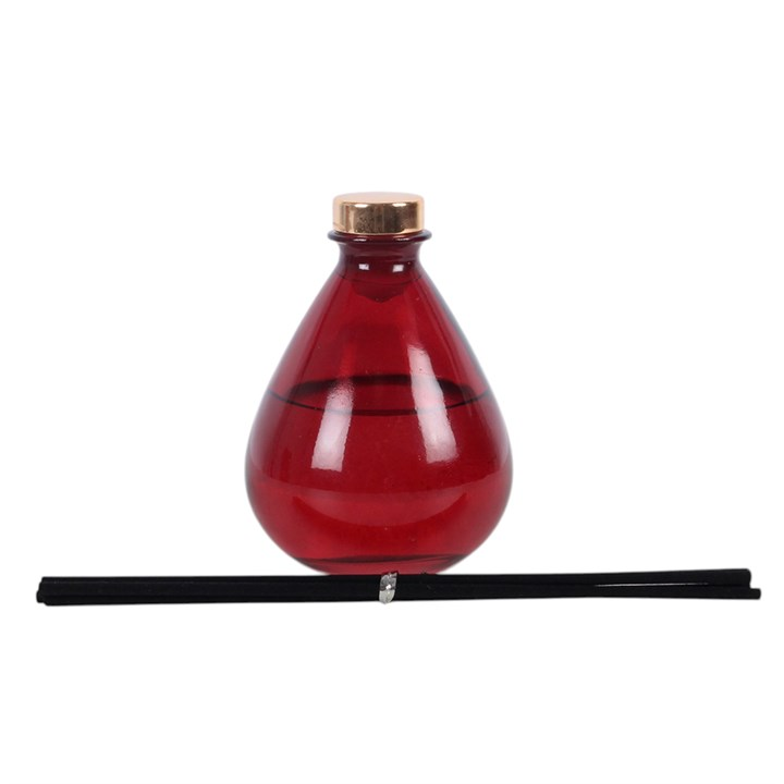 Vampire Blood reed diffuser. A deep red teardrop glass bottle with dark reeds.