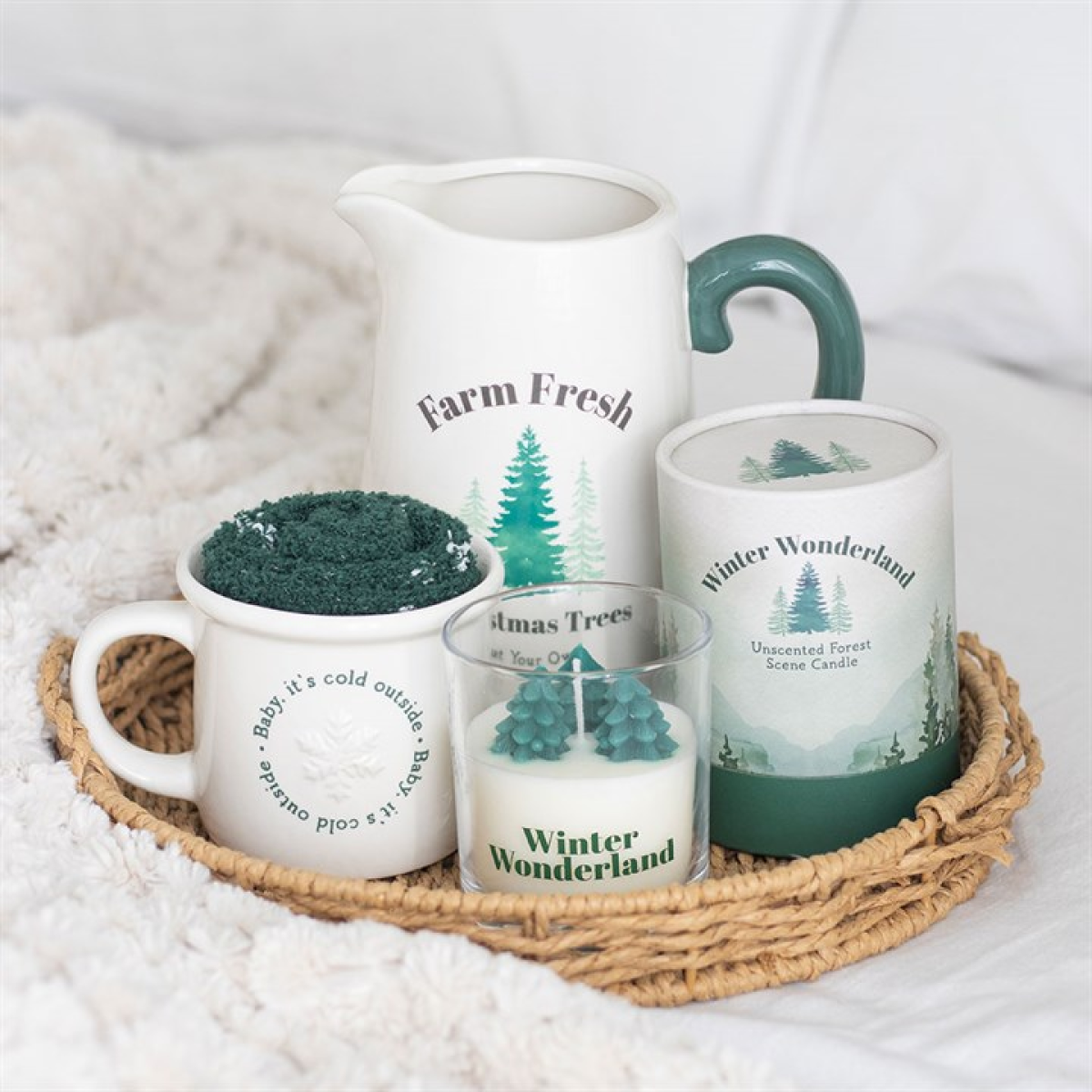 White ceramic pitcher style flower jug, with festive Farm Fresh Christmas Trees (Cut Your Own) design and coordinating green handle. Presented alongside other items from the same range.
