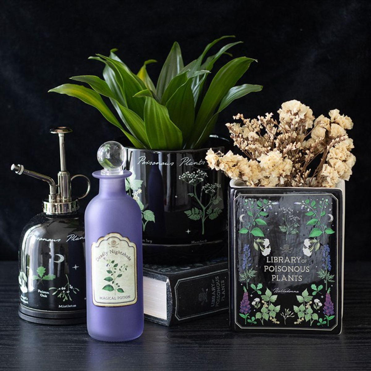 Library of Poisonous Plants book-shaped ceramic flower vase. Displayed alongside other items from the same range. 