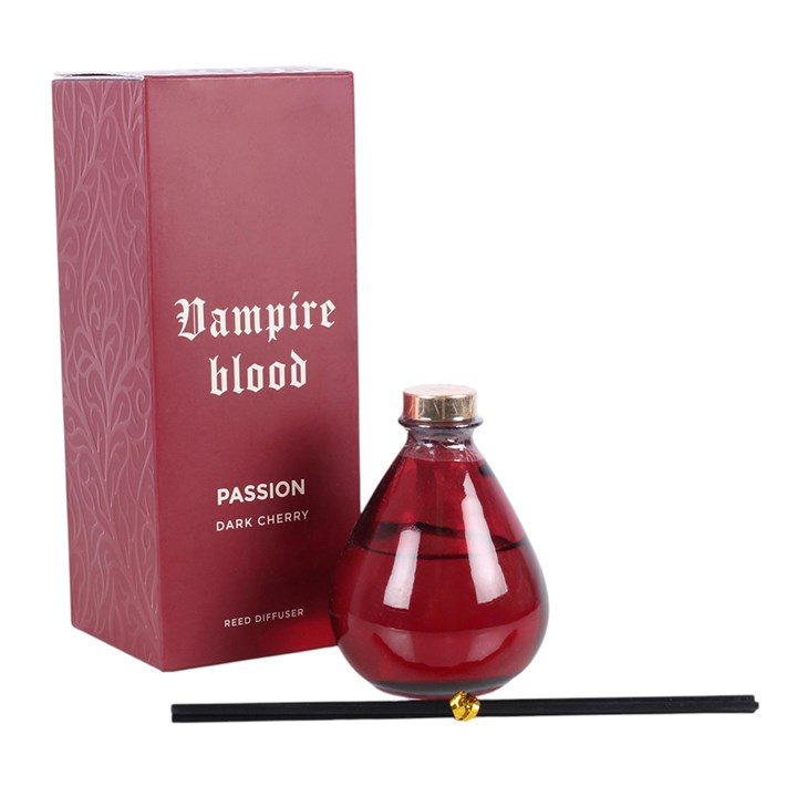 Vampire Blood reed diffuser. A deep red teardrop glass bottle with dark reeds.