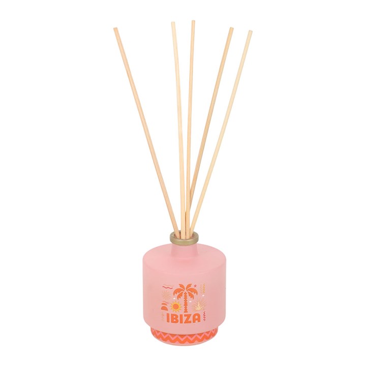 Ibiza reed diffuser, a soft pink bottle with orange palm tree and coastline inspired design. 
