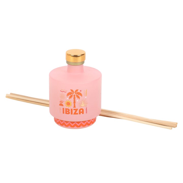 Ibiza reed diffuser, a soft pink bottle with orange palm tree and coastline inspired design. 