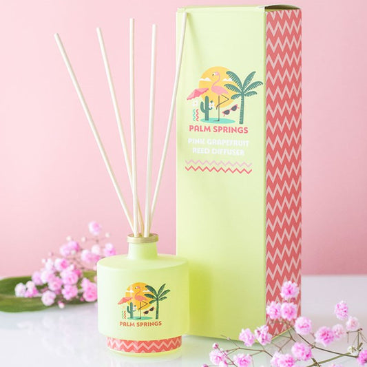 Palm Springs reed diffuser. Lime green bottle with palm tree and flamingo design. 