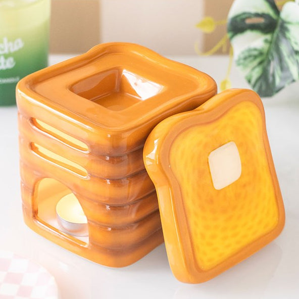 Stack of toast shaped ceramic wax melter and oil burner.
