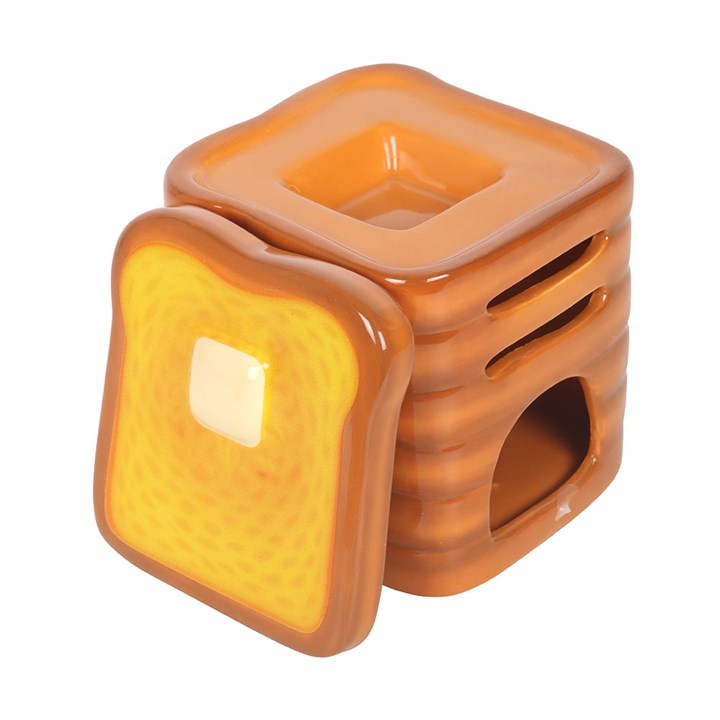 Stack of toast shaped ceramic wax melter and oil burner.