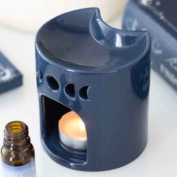 Blue ceramic crescent moon shaped oil burner.