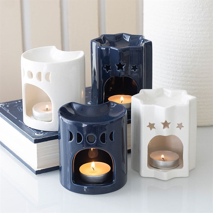 Blue ceramic oil burner, shaped like a celestial eight-point star. Presented alongside other items from the same range.