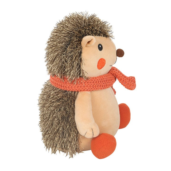 Woodland-themed weighted doorstop, shaped like a hedgehog with knitted orange scarf. 
