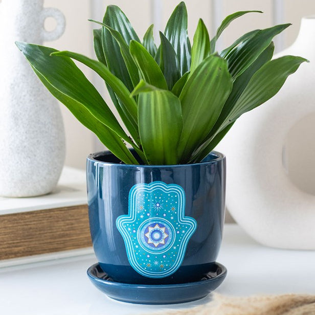 Dark blue ceramic plant pot with matching sauce and detailed Hand of Hamsa design.