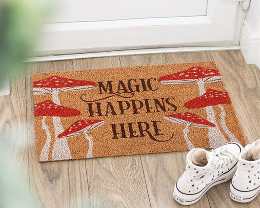 Decorative doormat with 'Magic Happens Here' text and a fantasy mushroom design.