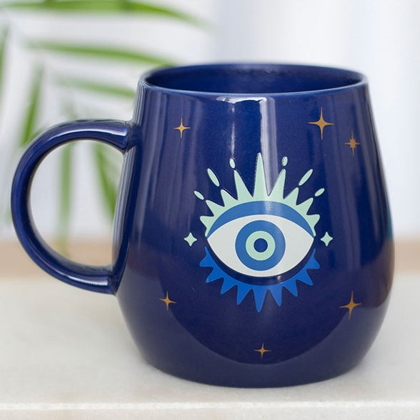 All Seeing Eye heat-changing ceramic mug. Design changes from a closed eye to an open eye when the mug is hot.