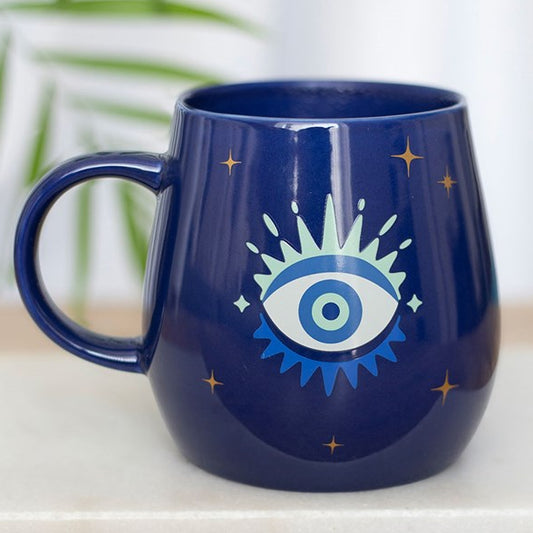 All Seeing Eye heat-changing ceramic mug. Design changes from a closed eye to an open eye when the mug is hot.